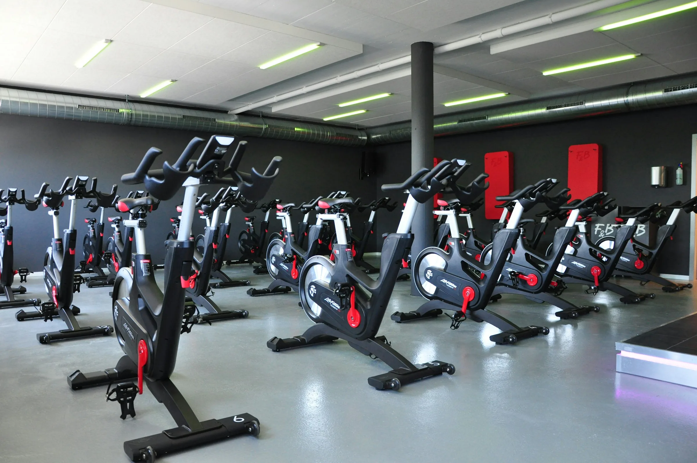 Rows of stationary bikes in the conditioning studio